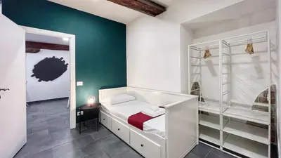 a bedroom with a white bed and a green wall at Charming Large Apartment - 3 Bedroom in Trastevere in Rome