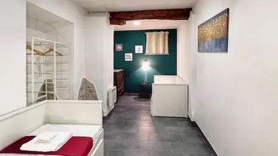 a bathroom with a red bench and a green wall at Charming Large Apartment - 3 Bedroom in Trastevere in Rome