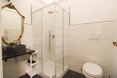 a bathroom with a shower and a toilet and a sink at Charming Large Apartment - 3 Bedroom in Trastevere in Rome
