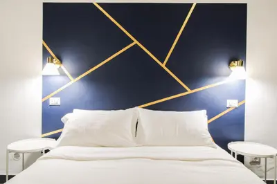 a bedroom with a white bed with two tables at Charming Large Apartment - 3 Bedroom in Trastevere in Rome