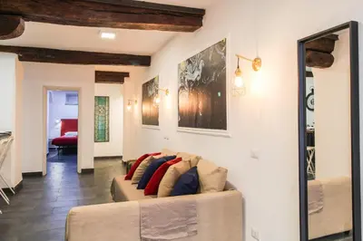 a living room with a couch with pillows on it at Charming Large Apartment - 3 Bedroom in Trastevere in Rome