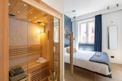 a bedroom with a bed and a glass shower at ROMAC Trinity - 3bdr apartment with Sauna & Jacuzzi in Campo de Fiori in Rome
