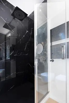 a bathroom with a shower with a glass door at ROMAC Trinity - 3bdr apartment with Sauna & Jacuzzi in Campo de Fiori in Rome