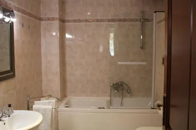 a bathroom with a tub and a sink and a bath tub at Colosseum New Charming Apartment in Rome
