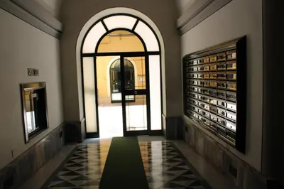 an empty hallway with a large window and a door at Colosseum New Charming Apartment in Rome