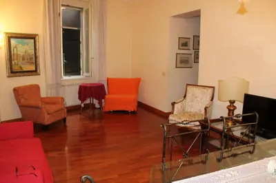 a living room with two chairs and a television at Colosseum New Charming Apartment in Rome