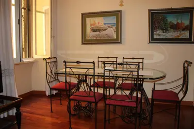 a dining room with a table and chairs at Colosseum New Charming Apartment in Rome