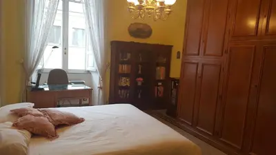 a bedroom with a bed and a chandelier at Luxury San Giovanni in Rome
