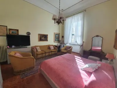 a bedroom with a bed and a living room at Luxury San Giovanni in Rome