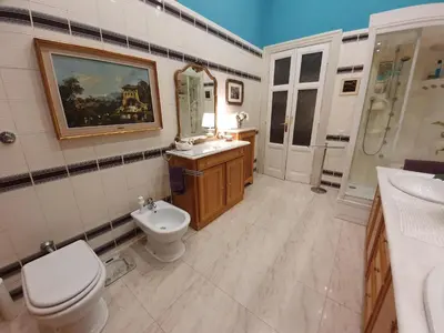 a bathroom with a toilet and a sink and a mirror at Luxury San Giovanni in Rome