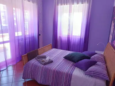 a purple bedroom with a bed with a stuffed animal on it at B&B Claudia a Monteverde in Rome