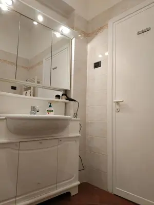 a white bathroom with a sink and a mirror at B&B Claudia a Monteverde in Rome