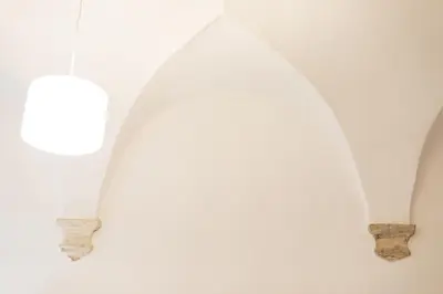 a group of three white vases on a wall at Leonardo Suite Pantheon in Rome