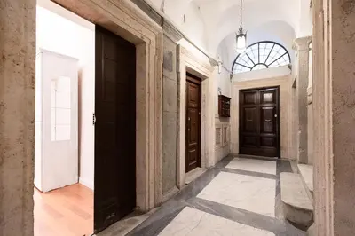 a hallway with wooden doors in a building at Leonardo Suite Pantheon in Rome