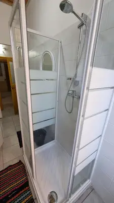 a shower with a glass door in a bathroom at SUNSHINE HOSTEL in Rome