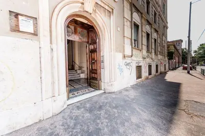 an old building with an open door on a street at SUNSHINE HOSTEL in Rome