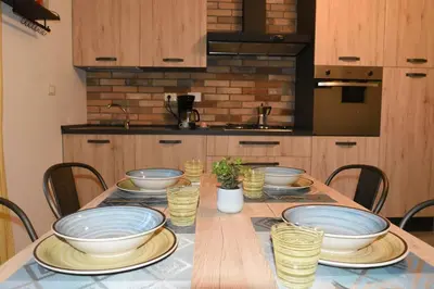 a table with bowls and plates on it in a kitchen at La casetta di Anastasia in Rome