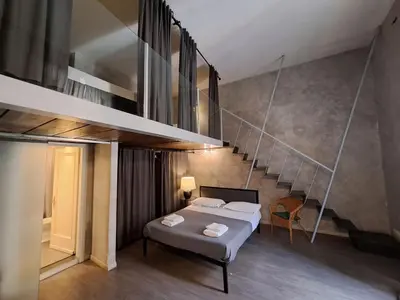 a bedroom with a bed and a staircase at Apartment Antico Balcone by Interhome in Rome