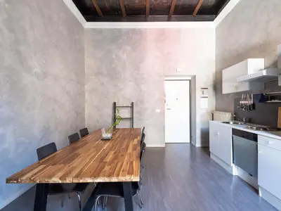 a dining room with a wooden table and a kitchen at Apartment Antico Balcone by Interhome in Rome