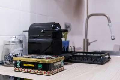 a kitchen counter with a coffee maker and a box on it at A Casa Lamperini 59 in Rome