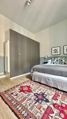 a bedroom with a bed and a rug on the floor at Colosseo Apartment 23 in Rome