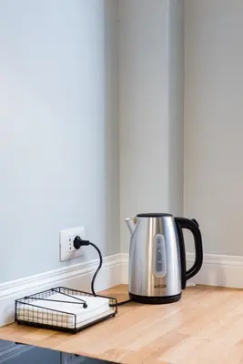 a tea kettle sitting on a counter next to an outlet at Colosseo Apartment 23 in Rome