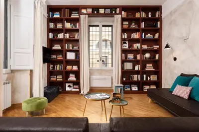 a living room with a couch and book shelves at Piazza del Popolo Boutique Home in Rome