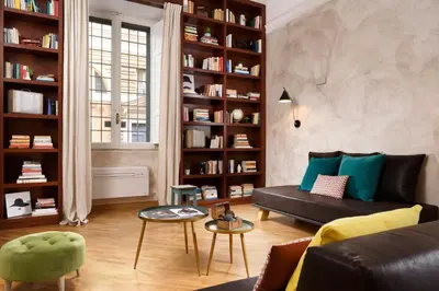 a living room with a couch and book shelves at Piazza del Popolo Boutique Home in Rome