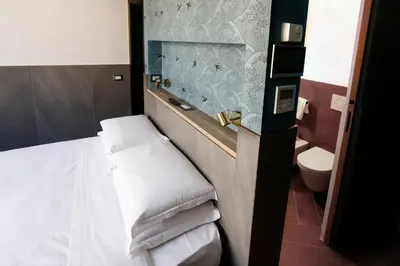 a hotel room with a bed and a toilet at Ottaviano Smart Rooms in Rome