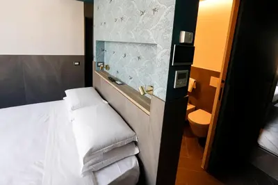 a hotel room with a bed and a toilet at Ottaviano Smart Rooms in Rome