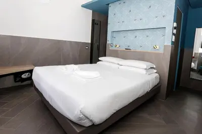 a large white bed in a hotel room at Ottaviano Smart Rooms in Rome