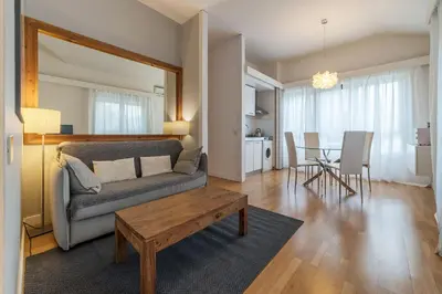 a living room with a couch and a table at GuestHost - Sant'Angelo Modern Apartment in Rome