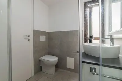a bathroom with a toilet and a sink at GuestHost - Sant'Angelo Modern Apartment in Rome