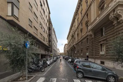 a street with cars parked on the side of a building at GuestHost - Sant'Angelo Modern Apartment in Rome