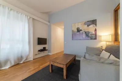 a living room with a couch and a table at GuestHost - Sant'Angelo Modern Apartment in Rome
