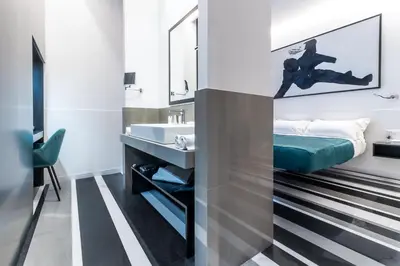 a bathroom with a bed and a sink at V-Accommodation IV Fontane in Rome