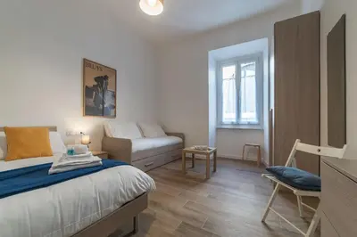 a bedroom with a bed and a couch in it at Roman Station House in Rome