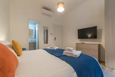 a bedroom with a large bed with towels on it at Roman Station House in Rome