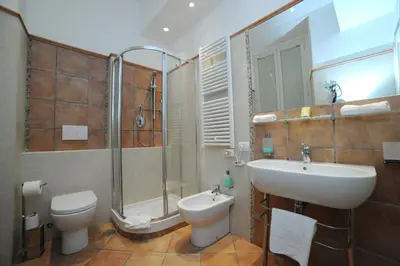 a bathroom with a sink and a toilet and a shower at RELAIS CAVOUR 133 in Rome