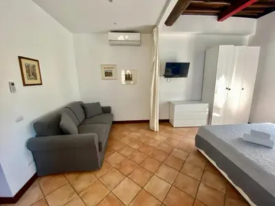 a bedroom with a couch and a bed and a television at RELAIS CAVOUR 133 in Rome