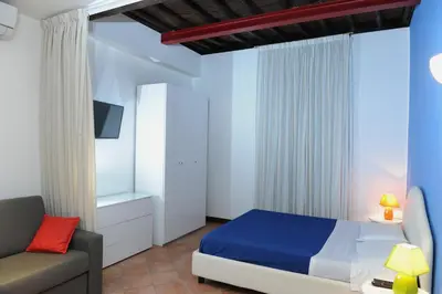 a bedroom with a bed and a couch at RELAIS CAVOUR 133 in Rome