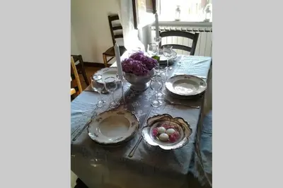 a table with plates and a bowl of fruit on it at La Finestra su Trastevere - Appartamento 100 mq Centrale, Luminoso, Spazioso in Rome
