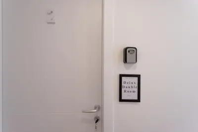 a white door with a sign on it at New Unico San Cosimato in Rome