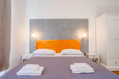 a bedroom with a bed with two towels on it at New Unico San Cosimato in Rome