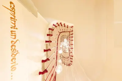 a chandelier hanging on a wall in a room at Poēsis Experience Hotel in Rome