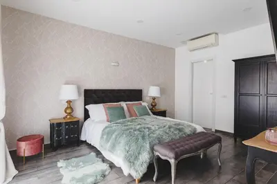 a bedroom with a large bed with a green blanket at La Suite al Vaticano in Rome