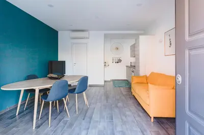 a living room with a table and chairs and a couch at La Suite al Vaticano in Rome