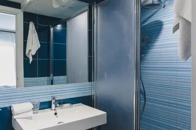 a bathroom with a sink and a mirror at La Suite al Vaticano in Rome