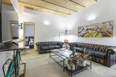 a living room with couches and a table at Industrial-Style Apartment Next To Vatican Metro in Rome