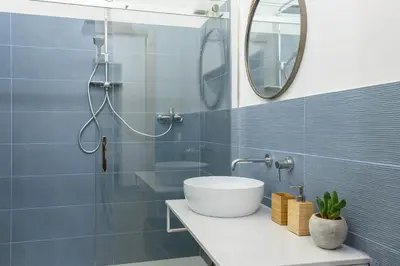 a bathroom with a sink and a shower with a mirror at Industrial-Style Apartment Next To Vatican Metro in Rome